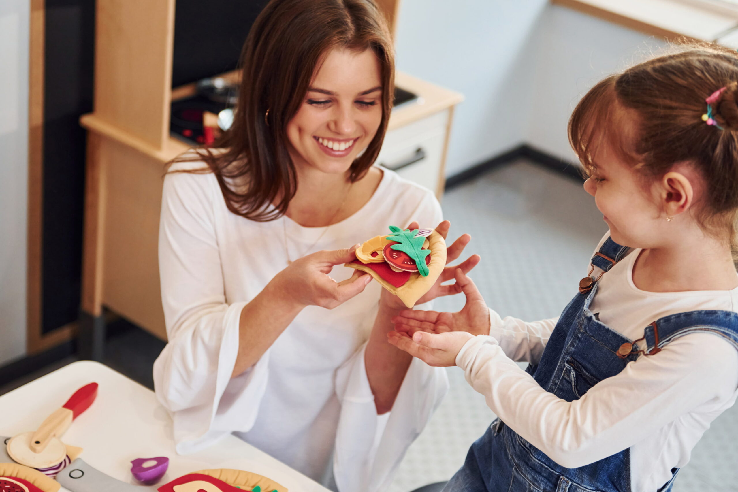 young-woman-with-little-girl-playing-with-toys-tog-2023-11-27-05-23-16-utc